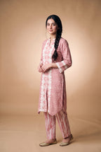 Model wearing the Blush Bandhani Lace Suit in blush pink with tie-dye-look trousers, full-length front view