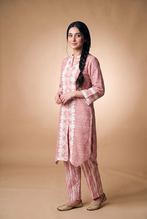 Model wearing the Blush Bandhani Lace Suit in blush pink with tie-dye-look trousers, full-length front view