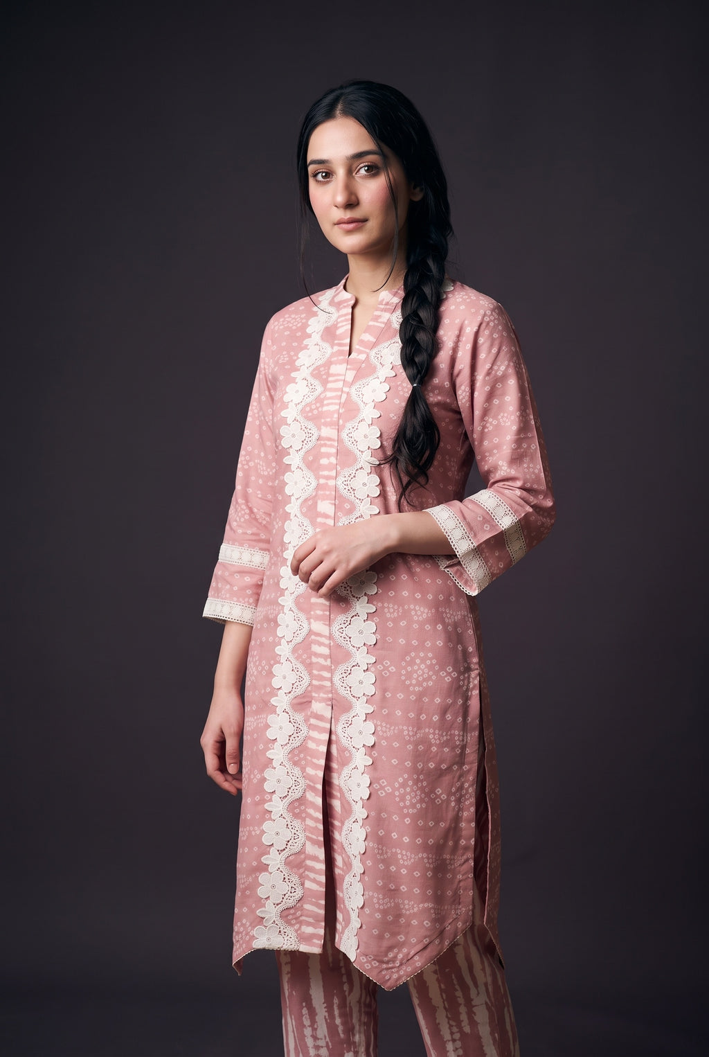 Model wearing the Blush Bandhani Lace Suit, showing the white floral lace down the front