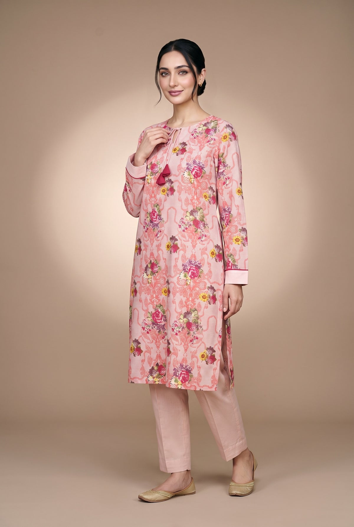 Model wearing the Blush Bouquet Suit in rose pink floral print, full-length front view