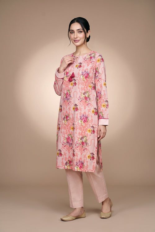 Model wearing the Blush Bouquet Suit in rose pink floral print, full-length front view