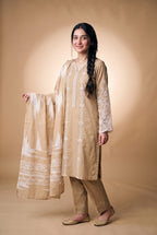 Model wearing the Fawn Eyelet Suit in fawn beige, full-length view holding the printed dupatta