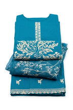 Blossom Tree Suit in peacock blue folded to show the tree panel, with the leaf-print dupatta and trousers