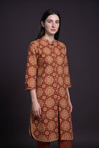 Model wearing the Maroon Star Tile Suit, showing the mandarin collar and front slit