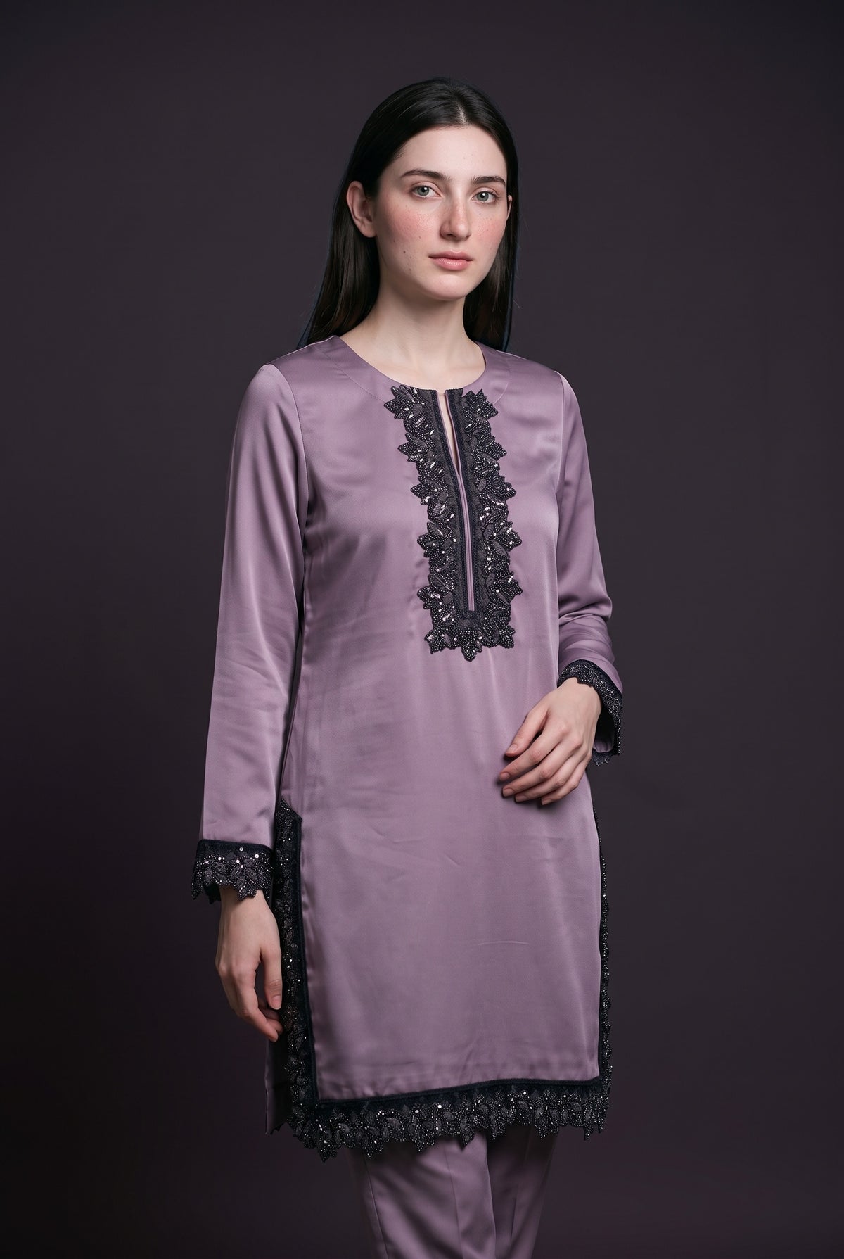 Model wearing the Mauve Noir Lace Suit, showing the beaded lace neckline panel