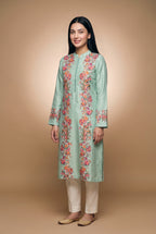 Model wearing the Garland Kurta in mint with plain cream trousers (not included), full-length front view