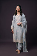 Model wearing the Misty Blue Cutwork Suit, showing the floral neckline and ivory cutwork hem