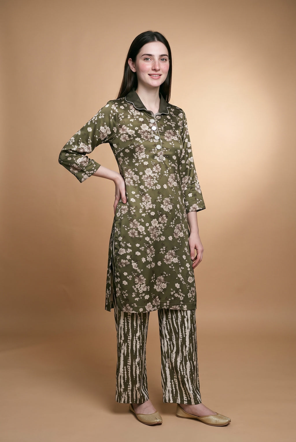 Model wearing the Olive Blossom Suit in olive floral print with zebra-stripe trousers, full-length front view