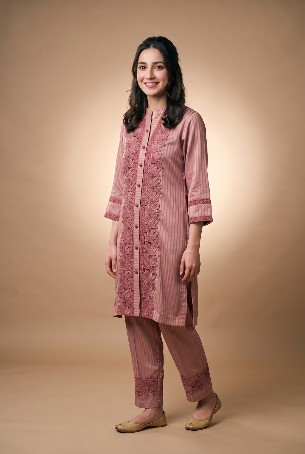 Model wearing the Rose Lotus Lace Suit in dusty rose, full-length front view with lace-trimmed trousers