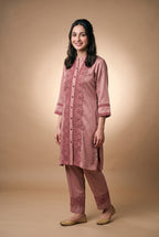 Model wearing the Rose Lotus Lace Suit in dusty rose, full-length front view with lace-trimmed trousers