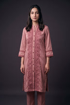 Model wearing the Rose Lotus Lace Suit, showing the lotus lace panels and buttoned placket