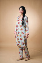 Model wearing the Sky Bouquet Suit in ice blue floral print, full-length view with matching printed trousers
