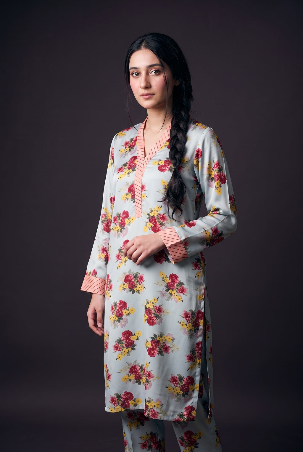 Model wearing the Sky Bouquet Suit, showing the striped pink V-neck band and cuffs