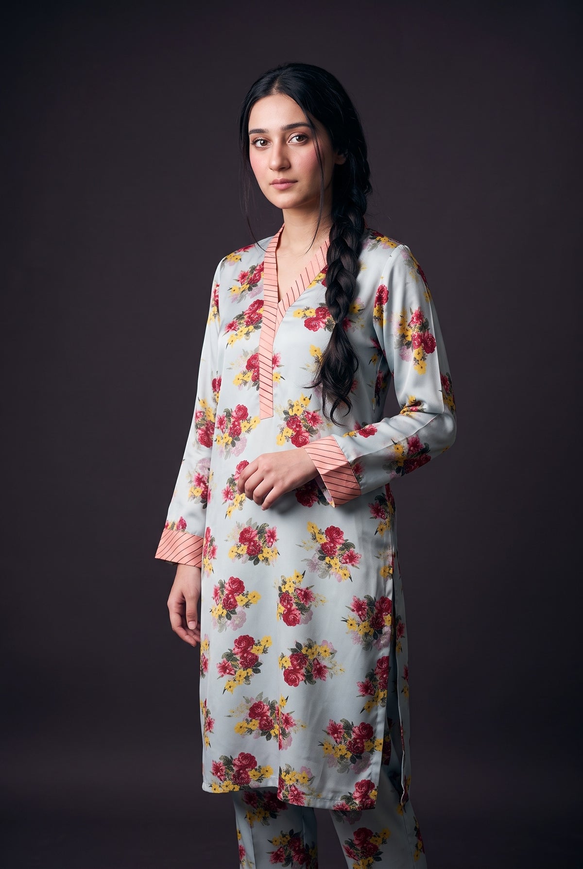 Model wearing the Sky Bouquet Suit, showing the striped pink V-neck band and cuffs